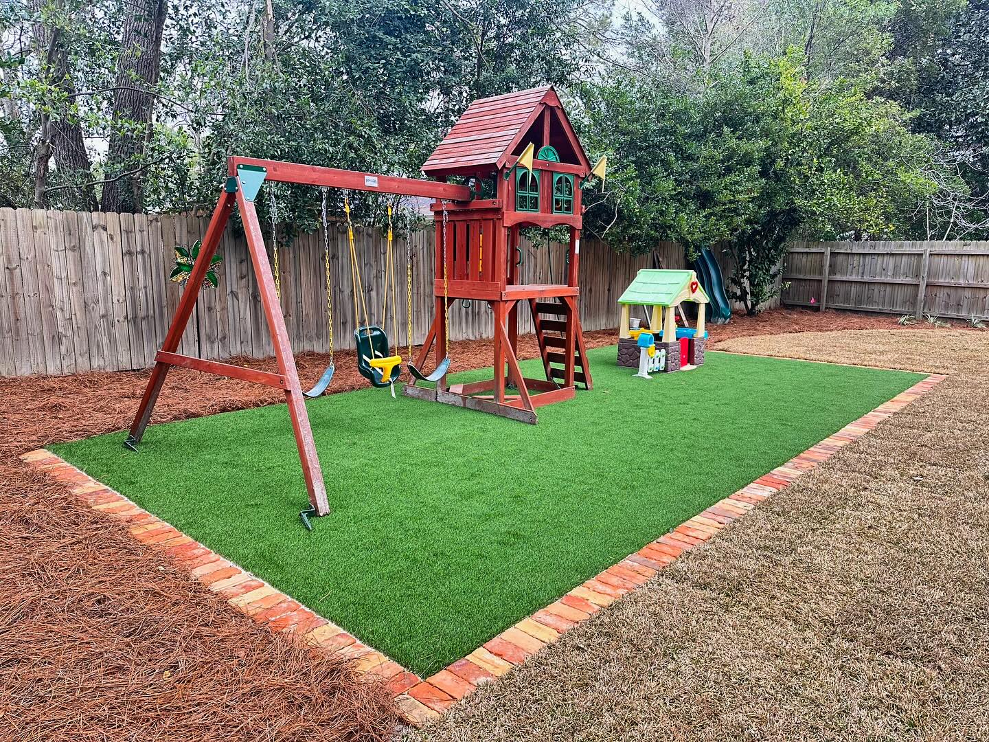 Backyard playground with synthetic turf