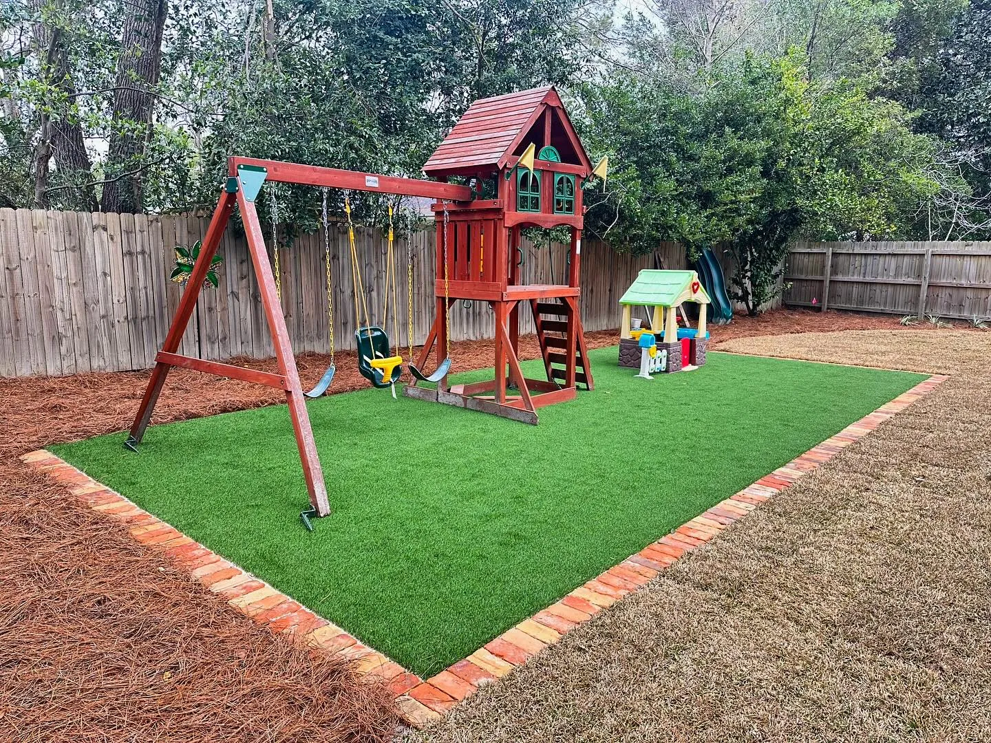 Backyard playground with synthetic turf