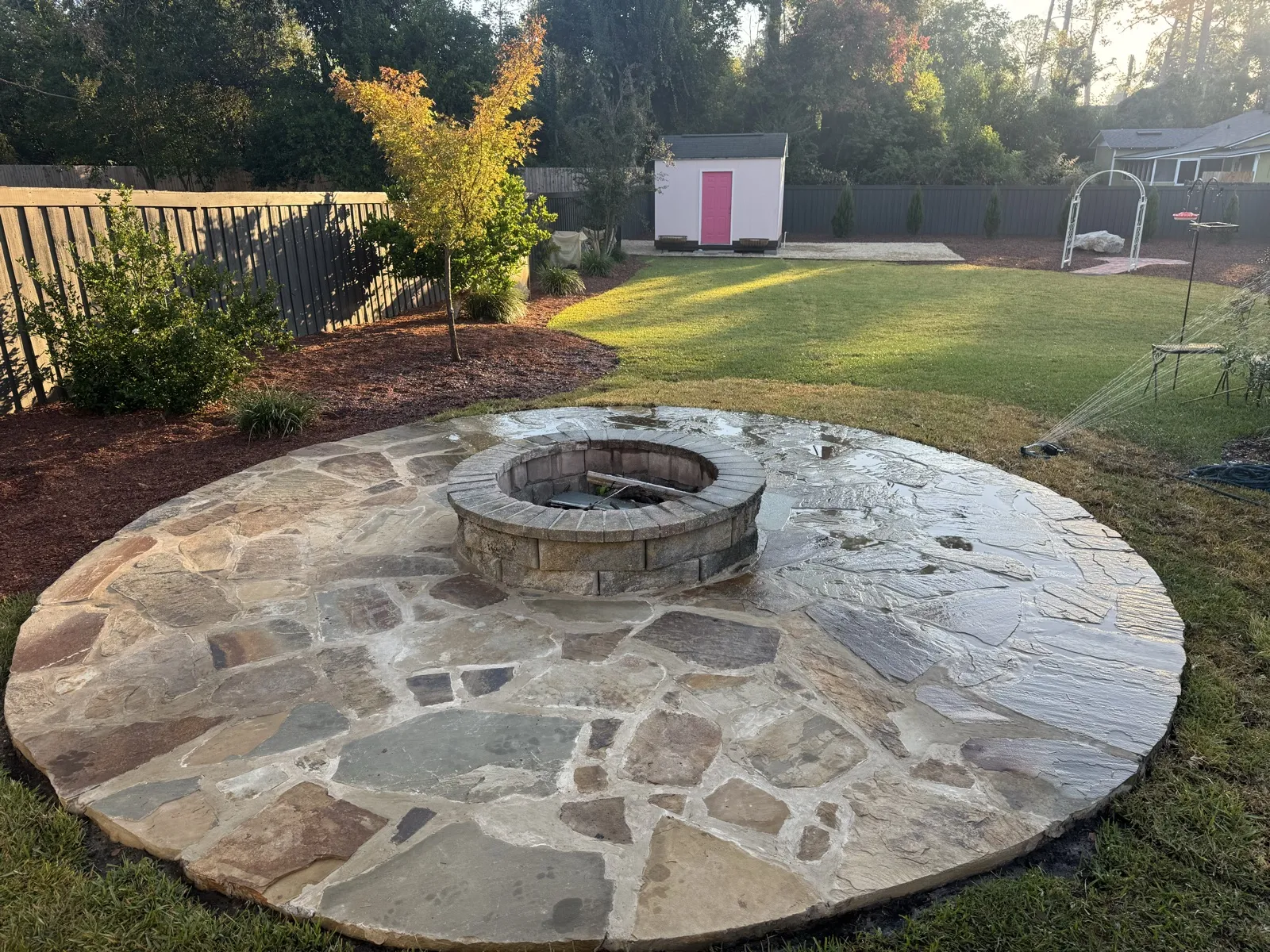 Stone fire pit with circular flagstone patio