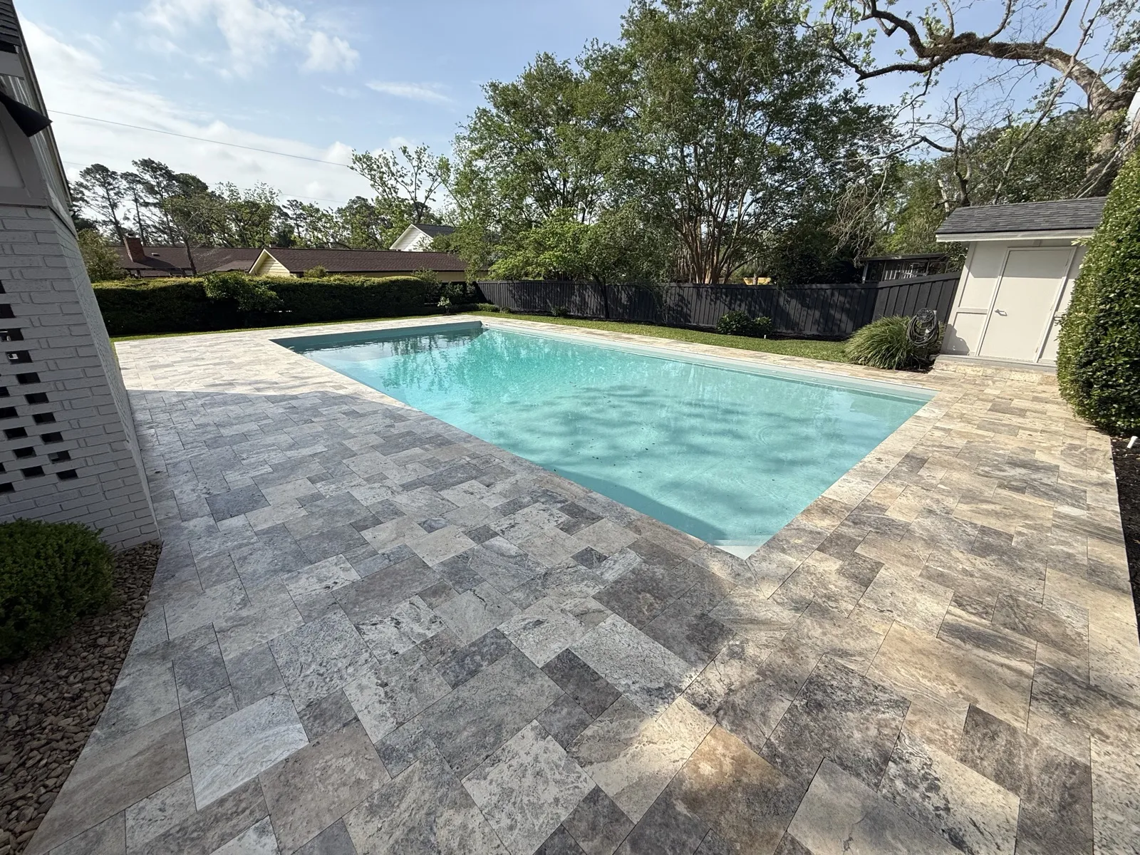 Poolside travertine paver deck