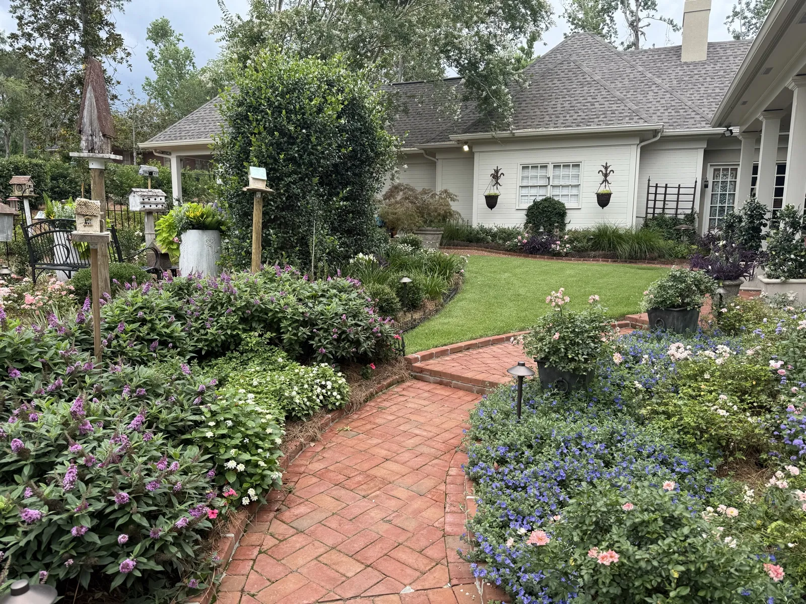 Custom garden design with brick walkway and colorful flower beds in Valdosta, GA