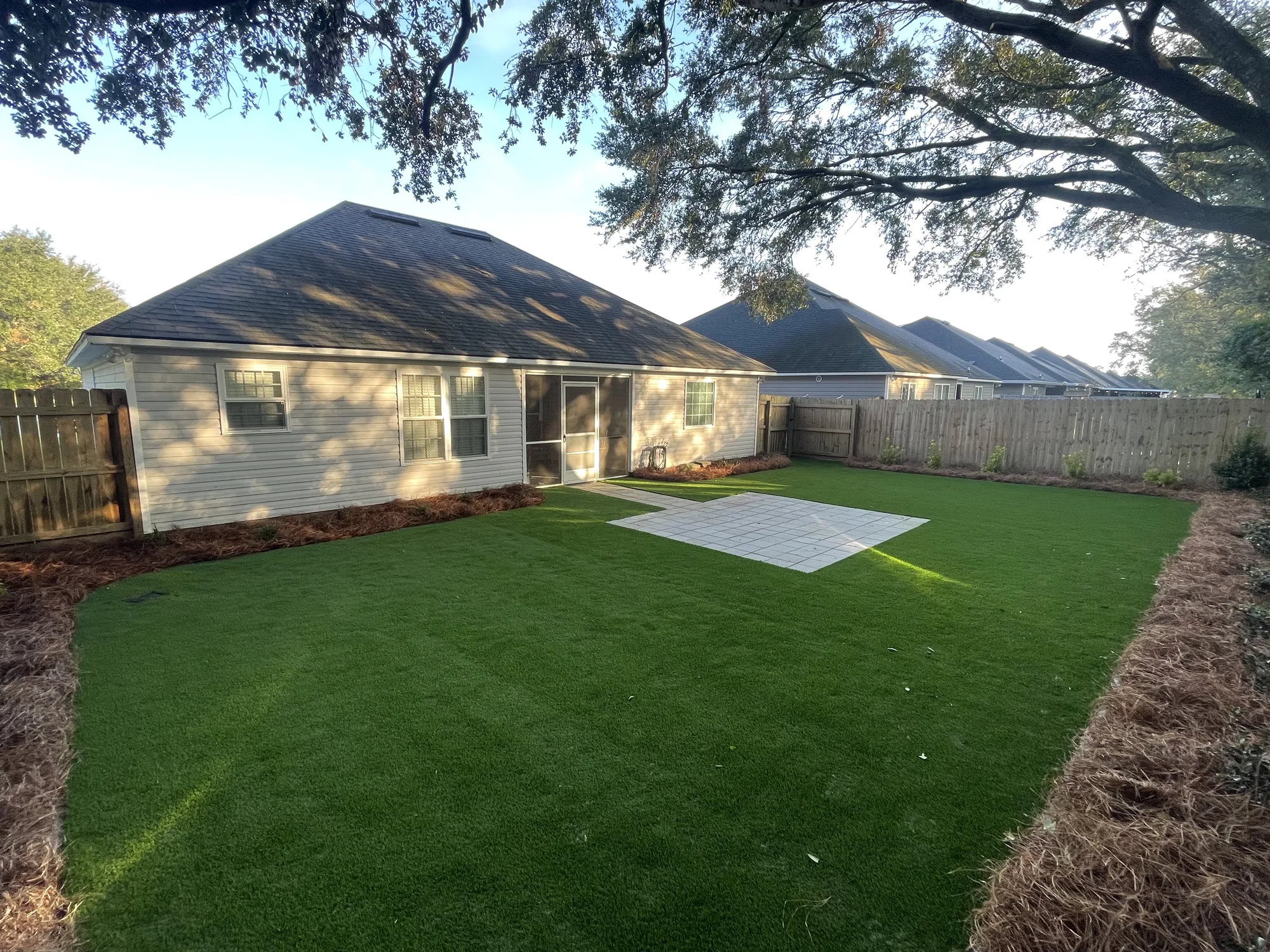Backyard synthetic turf with paver patio in Valdosta GA