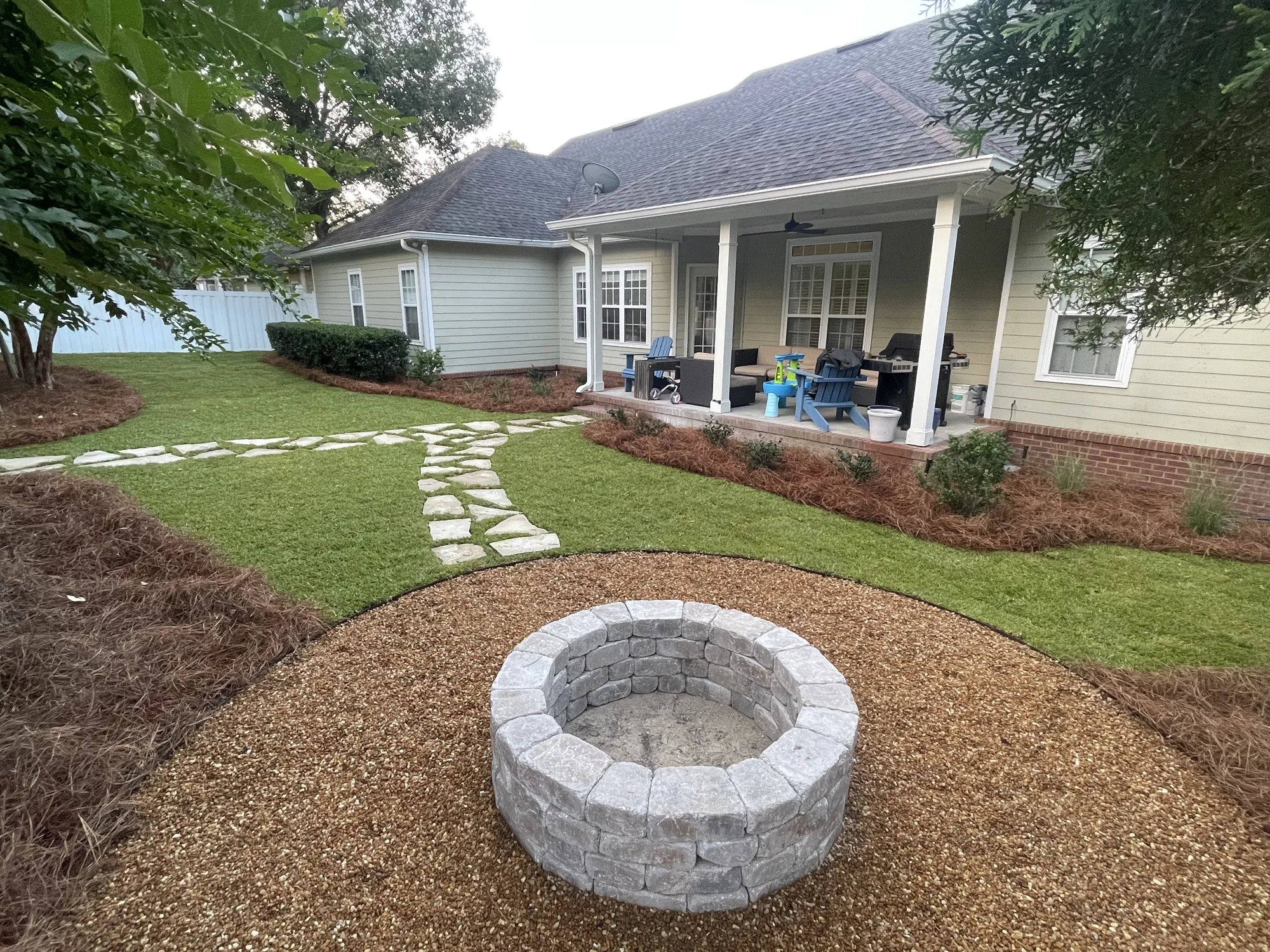 Stone fire pit with pea gravel and flagstone walkway in Valdosta GA