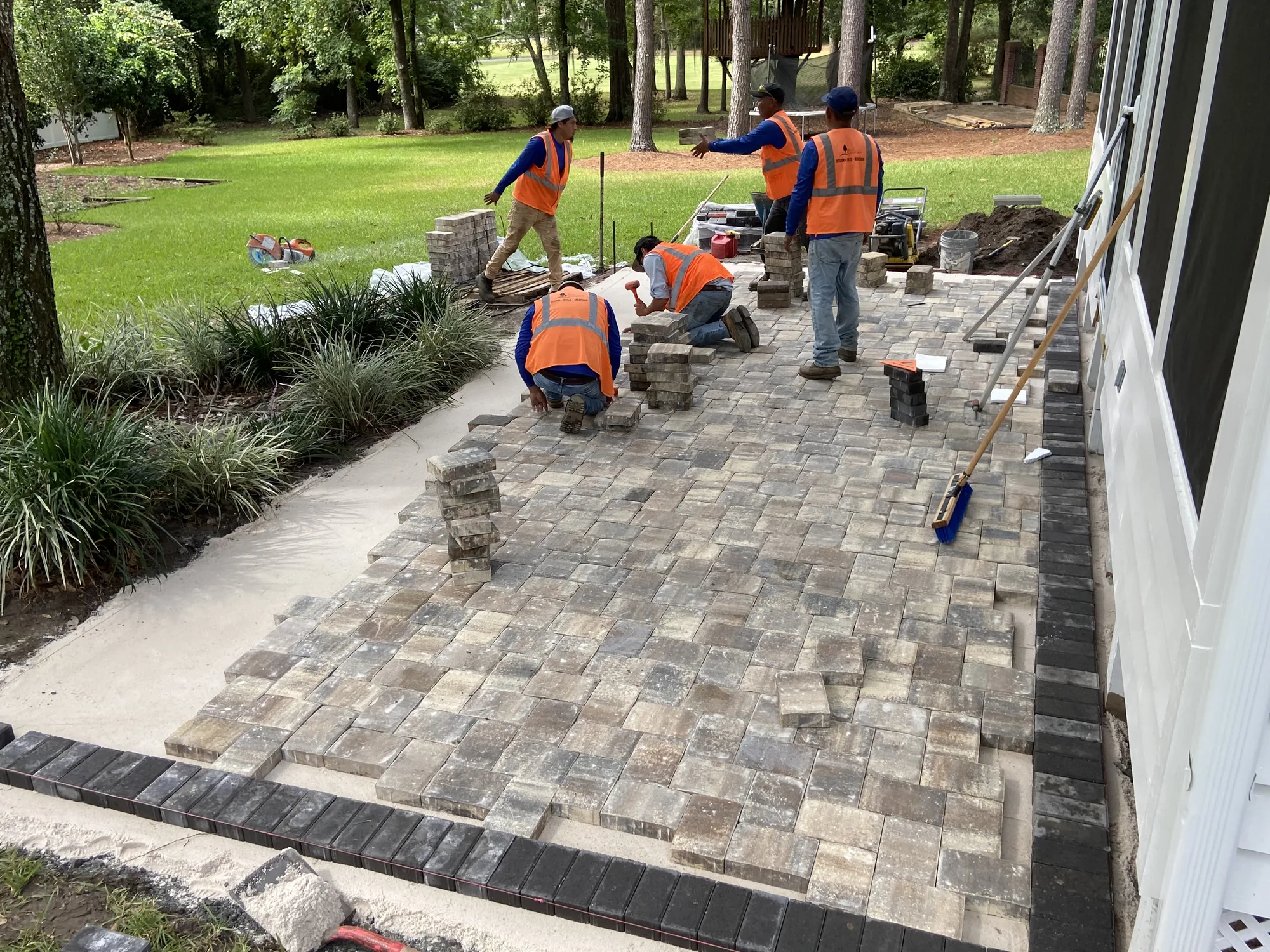 Elite Landscapes crew installing a paver patio