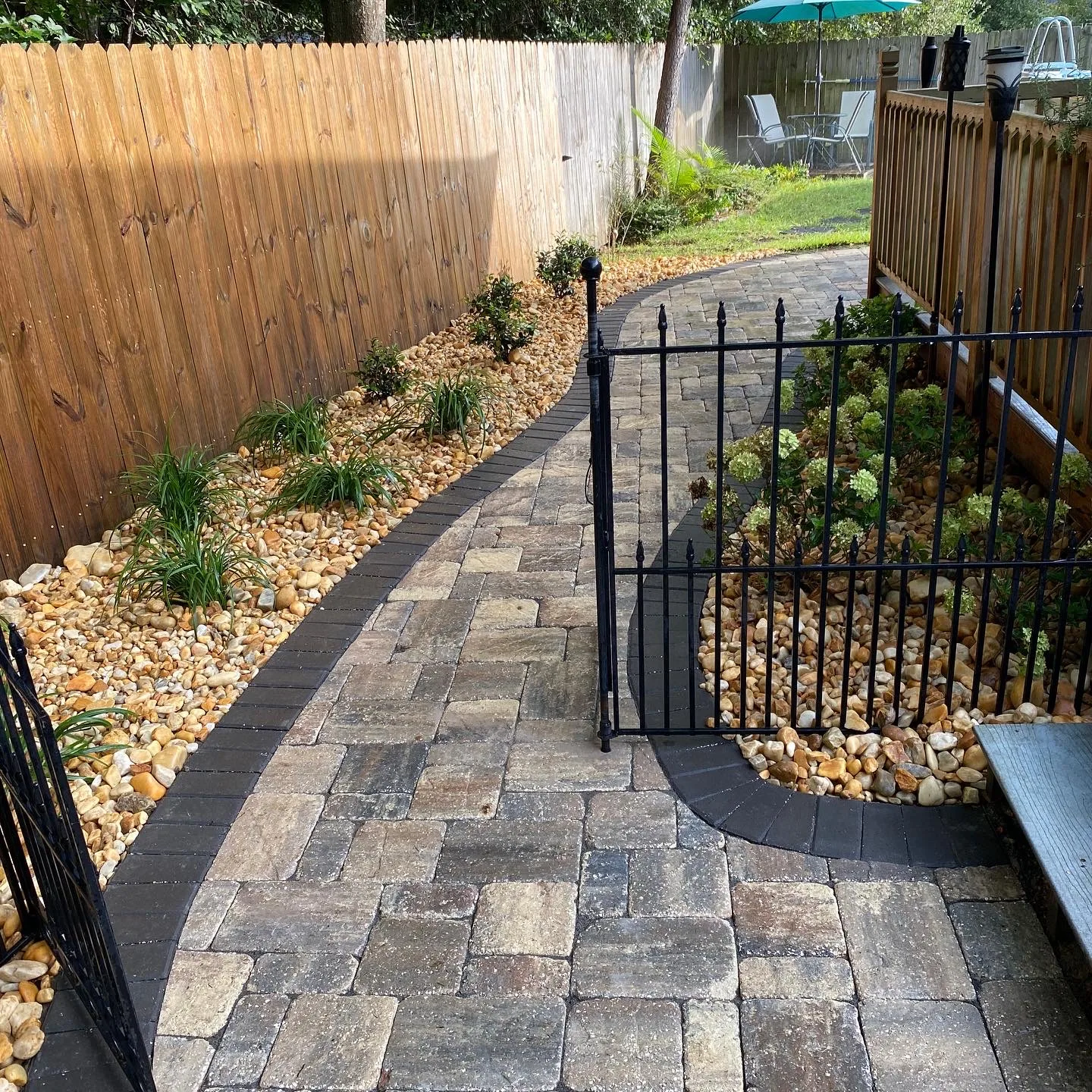 Paver walkway with river rock beds and plantings in Valdosta GA